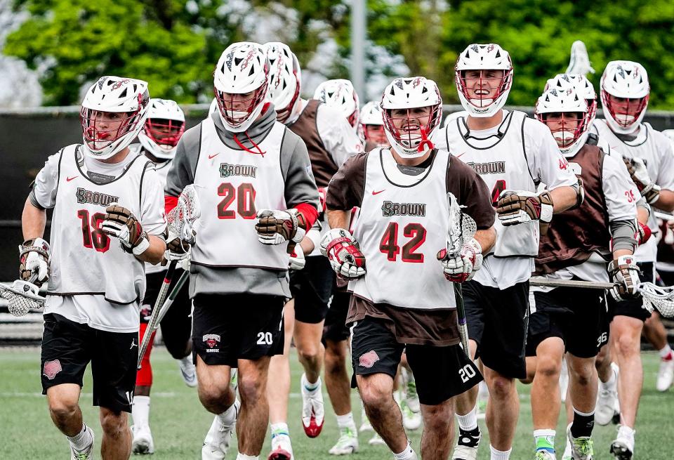 The Brown men's lacrosse team takes a jog together at the start of practice on Wednesday, ahead of Saturday's showdown with Virginia in the NCAA tournament.