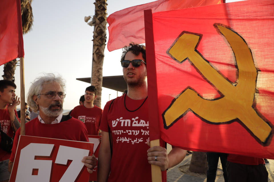 People protest against the conference in Bahrain, which focuses on the economic portion of the White House's long-awaited plan for Mideast peace, in Tel Aviv, Israel, Tuesday, June 25, 2019. At this week's conference, the Trump administration hopes to draw pledges from business leaders and wealthy Gulf states to fund its economic plan, which calls for $50 billion of investment and infrastructure projects in the West Bank, Gaza and neighboring Arab countries.(AP Photo/Sebastian Scheiner)