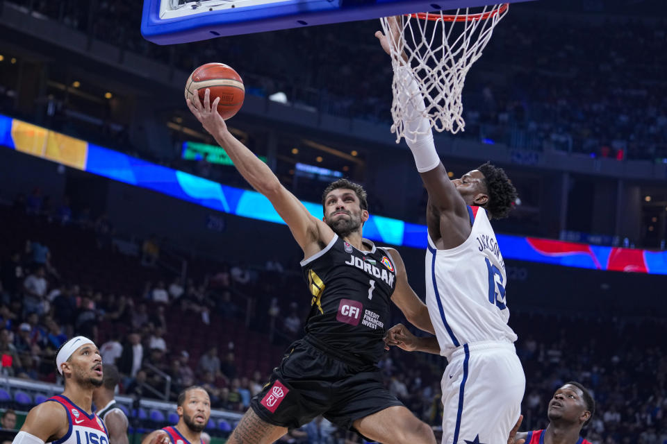 Jordan guard Amin Abu Hawwas (1) shoots under U.S. forward Jaren Jackson Jr. (13) during the first half of a Basketball World Cup group C match in Manila, Philippines Wednesday, Aug. 30, 2023. (AP Photo/Michael Conroy)