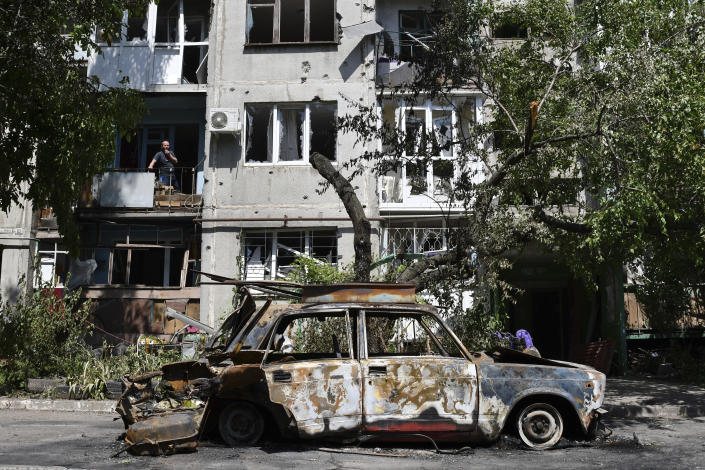 FILE - A destroyed car lies next to an apartment building damaged by an overnight missile strike in Slovyansk, Ukraine, Tuesday, May 31, 2022. (AP Photo/Andriy Andriyenko, File)