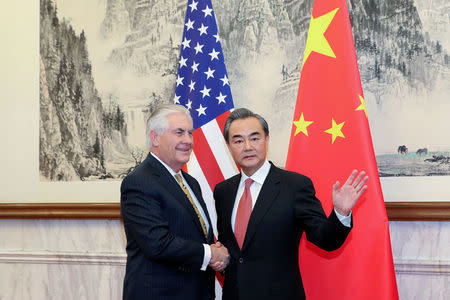 Chinese Foreign Minister Wang Yi (R) shakes hands with U.S. Secretary of State Rex Tillerson at Diaoyutai State Guesthouse on March 18, 2017 in Beijing, China. REUTERS/ Lintao Zhang/POOL