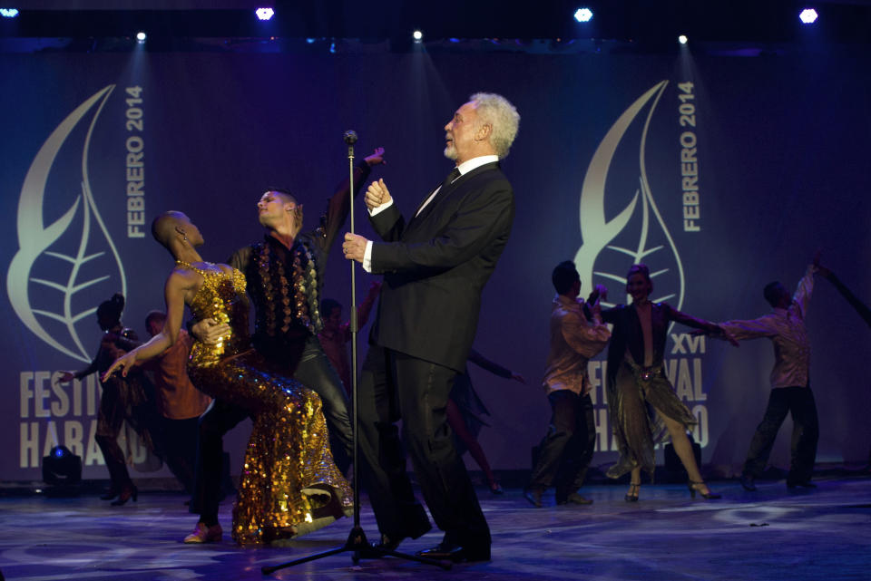 Welsh crooner Tom Jones performs during a gala dinner marking the end of the 16th annual Cigar Festival in Havana, Cuba, Friday, Feb. 28, 2014. The festival is a five-day bash that brings together hundreds of cigar sophisticates from around the world, and culminates with a gala and auction of humidors worth hundreds of thousands of dollars. Tom Jones was among the celebrity invitees at Saturday's auction and sang three songs for attending guests, including his signature "It's Not Unusual." (AP Photo/Franklin Reyes)