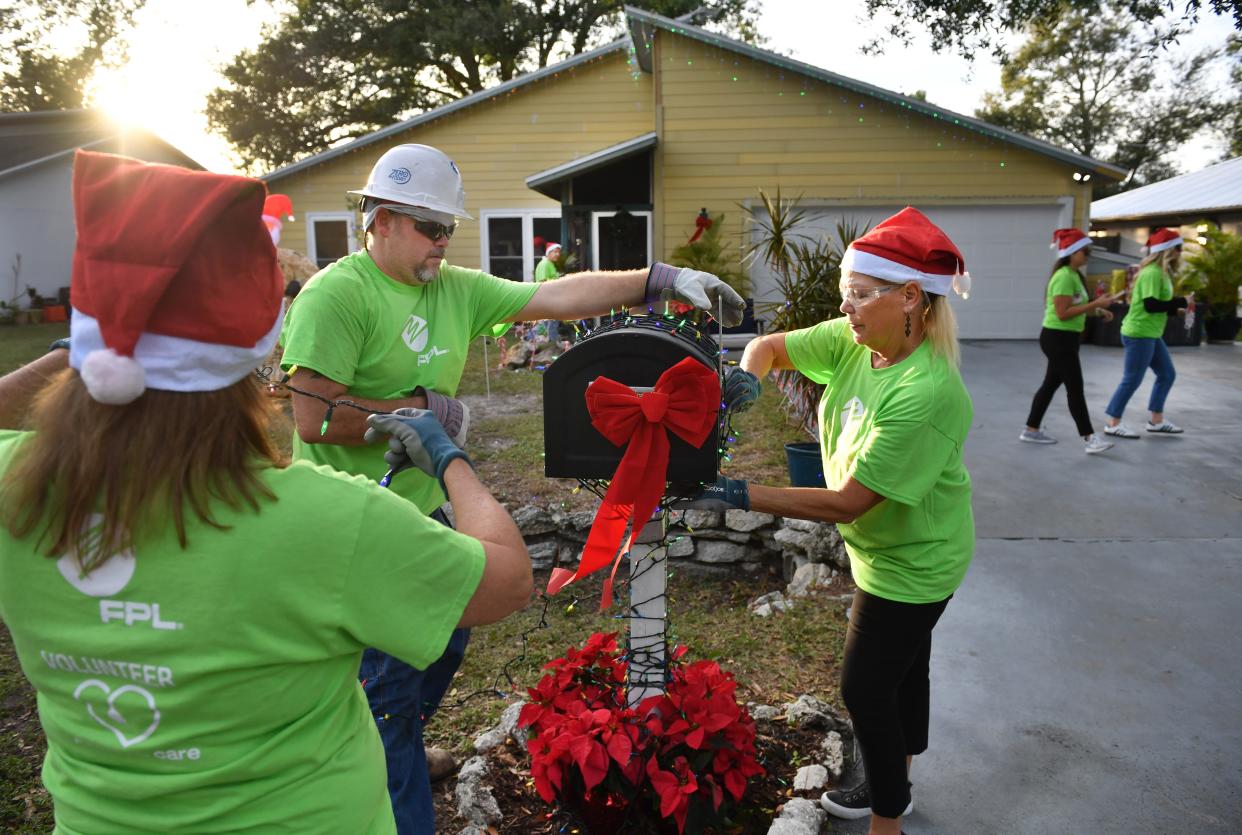 Florida Power & Light volunteers put the finishing touches on the home of veteran Rob Kehs before he gets home from work Monday. FPL partnered with Wishes for Heroes to decorate the home of U.S. Navy veteran Rob Kehs and his family on Monday, Dec. 4, 2023. Kehs was surprised with a completely decorated home when he got home from work.