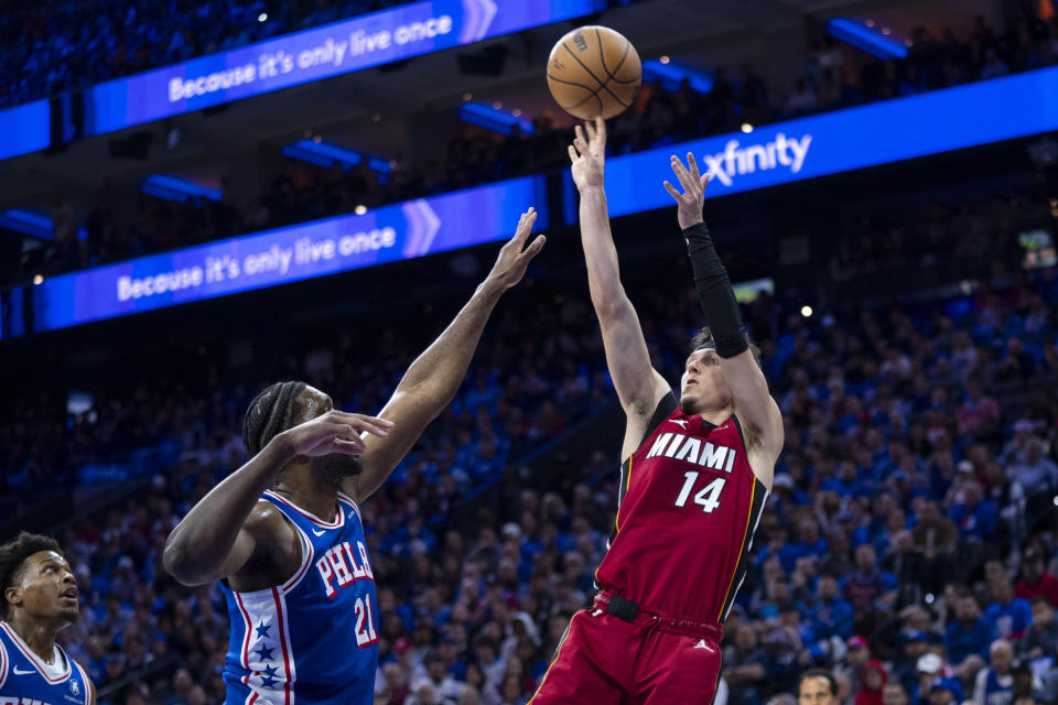 Miami Heat's Tyler Herro, right, shoots over Philadelphia 76ers' Joel Embiid during the first half of an NBA basketball play-in tournament game, Wednesday, April 17, 2024, in Philadelphia. (AP Photo/Chris Szagola)