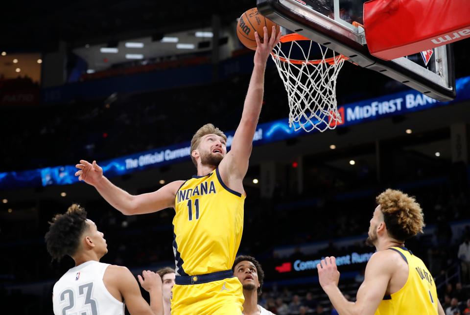 Jan 28, 2022; Oklahoma City, Oklahoma, USA; Indiana Pacers forward Domantas Sabonis (11) goes to the basket as Oklahoma City Thunder guard Tre Mann (23) looks on during the first quarter at Paycom Center. Mandatory Credit: Alonzo Adams-USA TODAY Sports