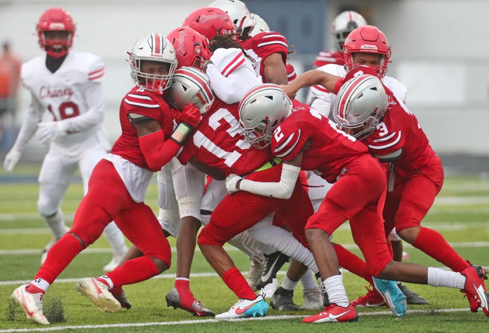 East's Zivelle Thomas, Malcolm Ellen, Garland Toney and Darshaun Sales team up to stop Chaney's Darius Stonework on Thursday in Akron.