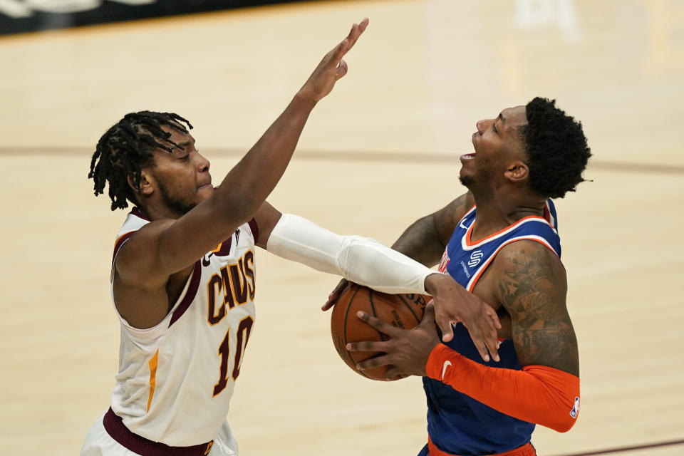 Cleveland Cavaliers' Darius Garland (10) fouls New York Knicks' Elfrid Payton during the second half of an NBA basketball game, Tuesday, Dec. 29, 2020, in Cleveland. The Knicks won 95-86. (AP Photo/Tony Dejak)