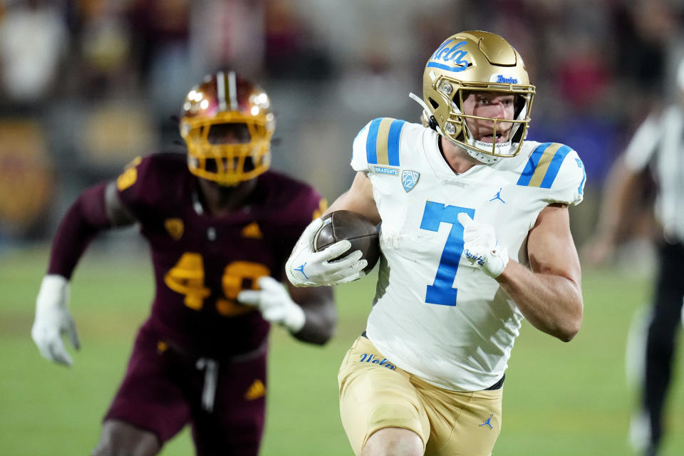 UCLA wide receiver Colson Yankoff (7) runs past Arizona State defensive lineman Travez Moore (49) during the second half of an NCAA college football game in Tempe, Ariz., Saturday, Nov. 5, 2022. UCLA won 50-36. (AP Photo/Ross D. Franklin)