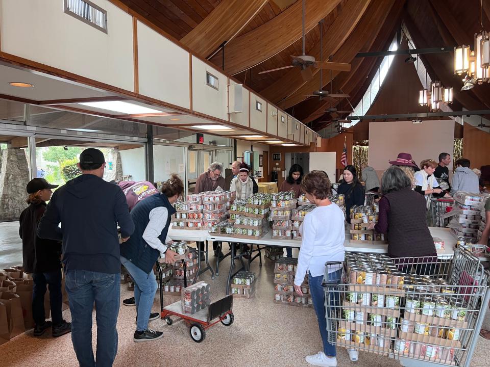 Volunteers pack up Thanksgiving meals to be delivered to hundreds of needy families.