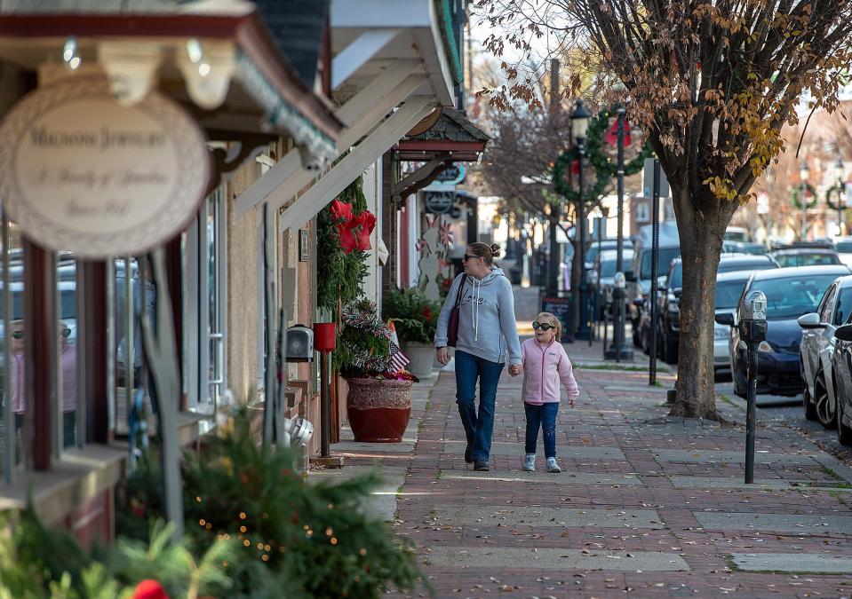 residents, Karena Mazur, (left), goes window shopping with her daughter, Makenna Mazur, 4, along Mill Street in Bristol Borough, on Wednesday, Dec. 1, 2021.