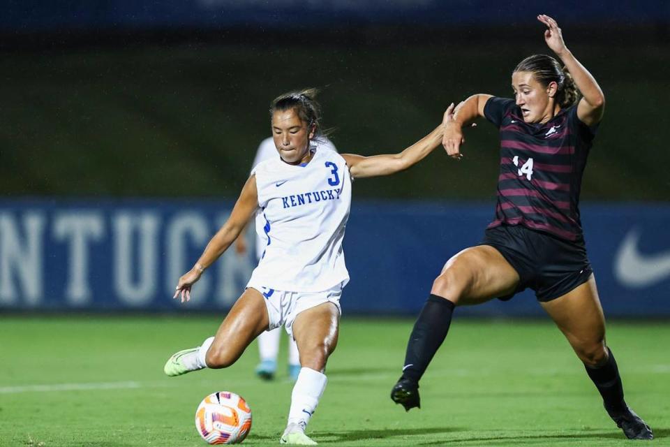 Kentucky senior midfielder Anna Young (3) takes a shot on goal past Eastern Kentucky senior defender Mackenzie Burdick (14) at the Wendell & Vickie Bell Soccer Complex on Thursday. Young appeared in all 18 matches for UK last season, making 16 starts.