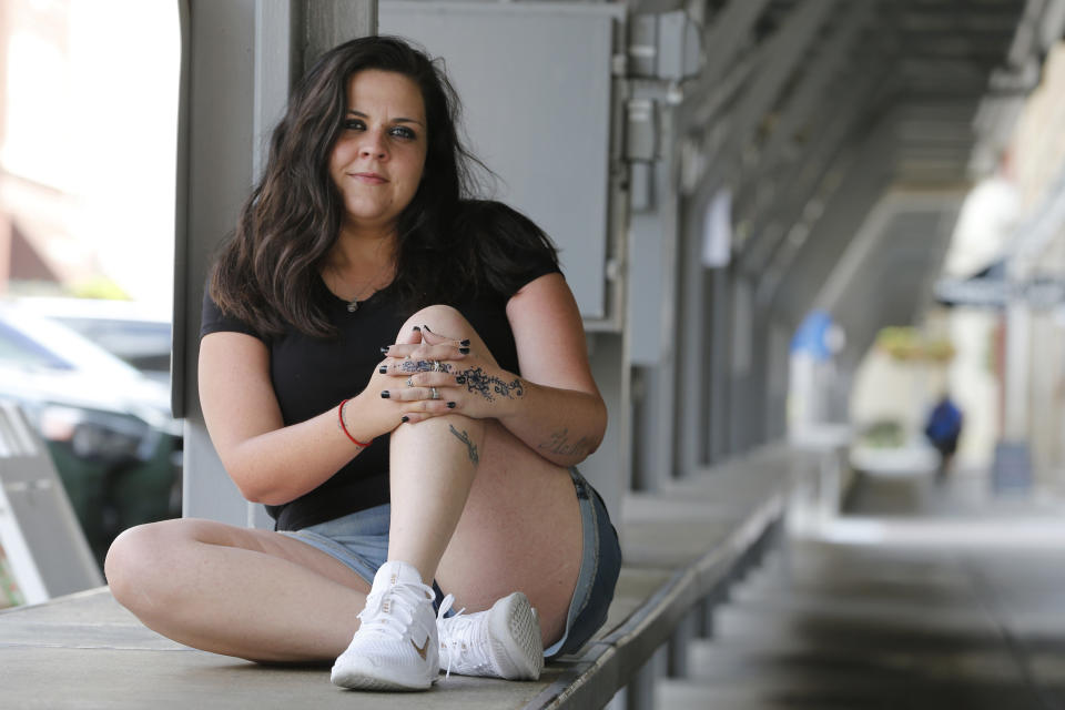 Former Fluvanna Correctional Center for Women inmate Stephanie Parris sits in Market Square on Wednesday, July 15, 2020, in Roanoke, Va. Parris was finishing a two-year prison sentence for a probation violation when she heard she’d be going home three weeks early because of COVID-19. (AP Photo/Steve Helber)