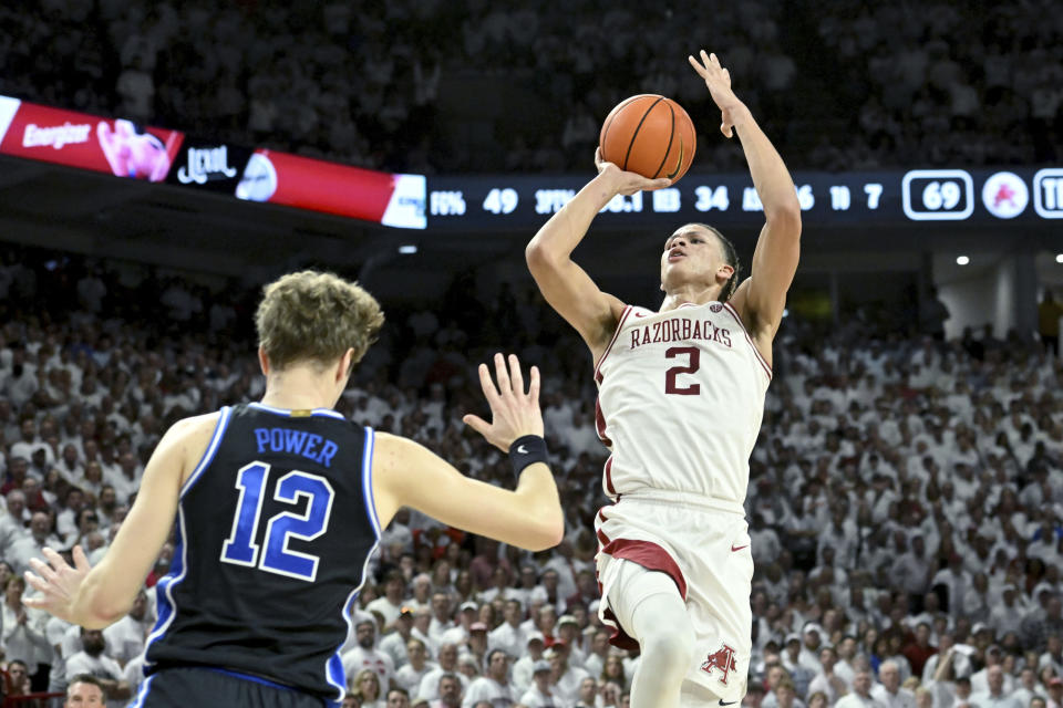 Arkansas forward Trevon Brazile (2) is fouled as he shoots over Duke forward TJ Power (12) during the second half of an NCAA college basketball game Wednesday, Nov. 29, 2023, in Fayetteville, Ark. (AP Photo/Michael Woods)