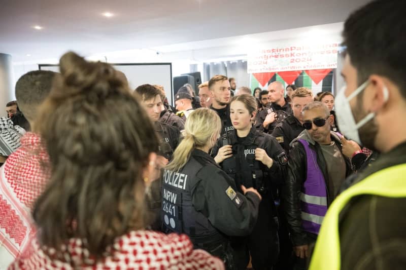 Police officers interrupt the Palestine Congress 2024. German police on Friday broke up a pro-Palestinian conference in the capital Berlin and asked some 250 participants to leave the venue just two hours into the three-day event. Officers had already intervened in the event during a speech via video by an activist who is banned from political activity in Germany. Sebastian Christoph Gollnow/dpa