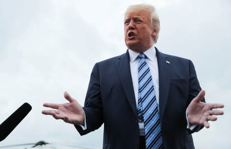 U.S. President Trump talks to reporters as he boards Air Force One for travel to Pennsylvania from Morristown Municipal Airport in Morristown, New Jersey