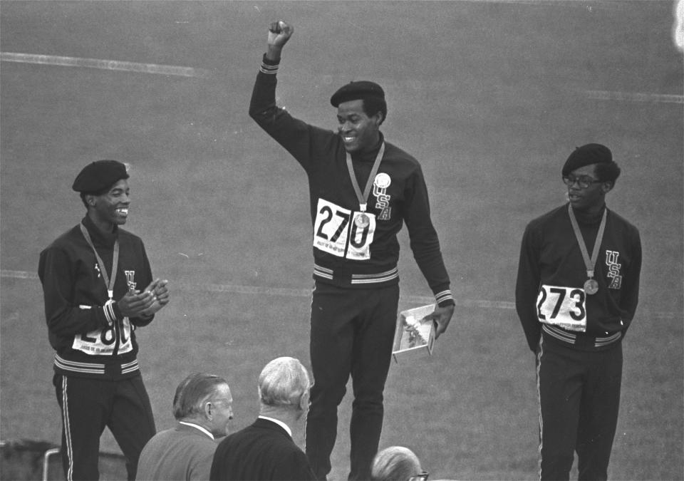 FILE - United States runners Larry James, left, Lee Evans, center, and Ron Freeman are shown after receiving their medals for the 400-meter race at the Mexico City Games in Mexico City, in this Oct. 18, 1968, file photo. Evans won gold, James took silver and Freeman got the bronze medal. Lee Evans, the record-setting sprinter who wore a black beret in a sign of protest at the 1968 Olympics, died Wednesday, May 19, 2021. He was 74. USA Track and Field confirmed Evans' death. The San Jose Mercury News reported that Evans' family had started a fundraiser with hopes of bringing him back to the U.S. from Nigeria, where he coached track, to receive medical care after he suffered a stroke last week.(AP Photo/File)