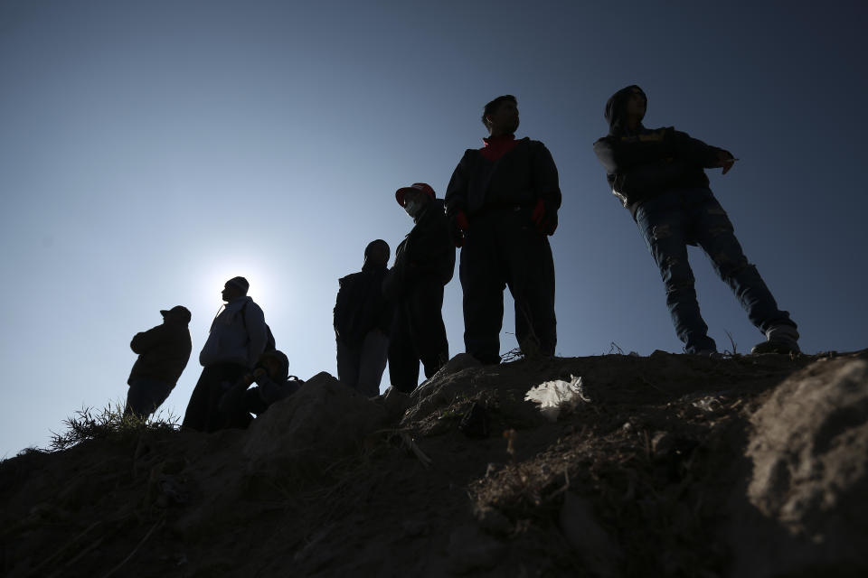 Migrants stand near the U.S.-Mexico border in Ciudad Juarez, Mexico, Monday, Dec. 19, 2022. Pandemic-era immigration restrictions in the U.S. known as Title 42 are set to expire on Dec. 21. (AP Photo/Christian Chavez)