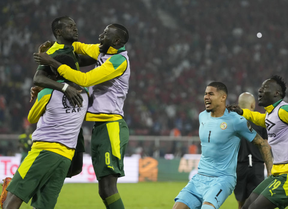 FILE - Senegal's Sadio Mane, top left, and teammates celebrate after scoring the winning penalty at the end of the African Cup of Nations 2022 final soccer match between Senegal and Egypt at the Ahmadou Ahidjo stadium in Yaounde, Cameroon, Sunday, Feb. 6, 2022. The penalty shootout is a tense battle of wills over 12 yards (11 meters) that has increasingly become a huge part of soccer and an unavoidable feature of the knockout stage in the biggest competitions. (AP Photo/Themba Hadebe, File)