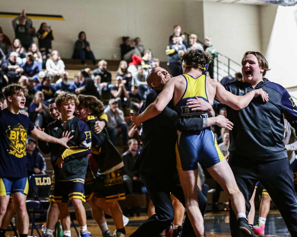 Elco coach Ben Moser gives a huge hug to Eli Krow after his pin sealed the Raiders' victory against Northern Lebanon to wrap up the LL Section 3 title.