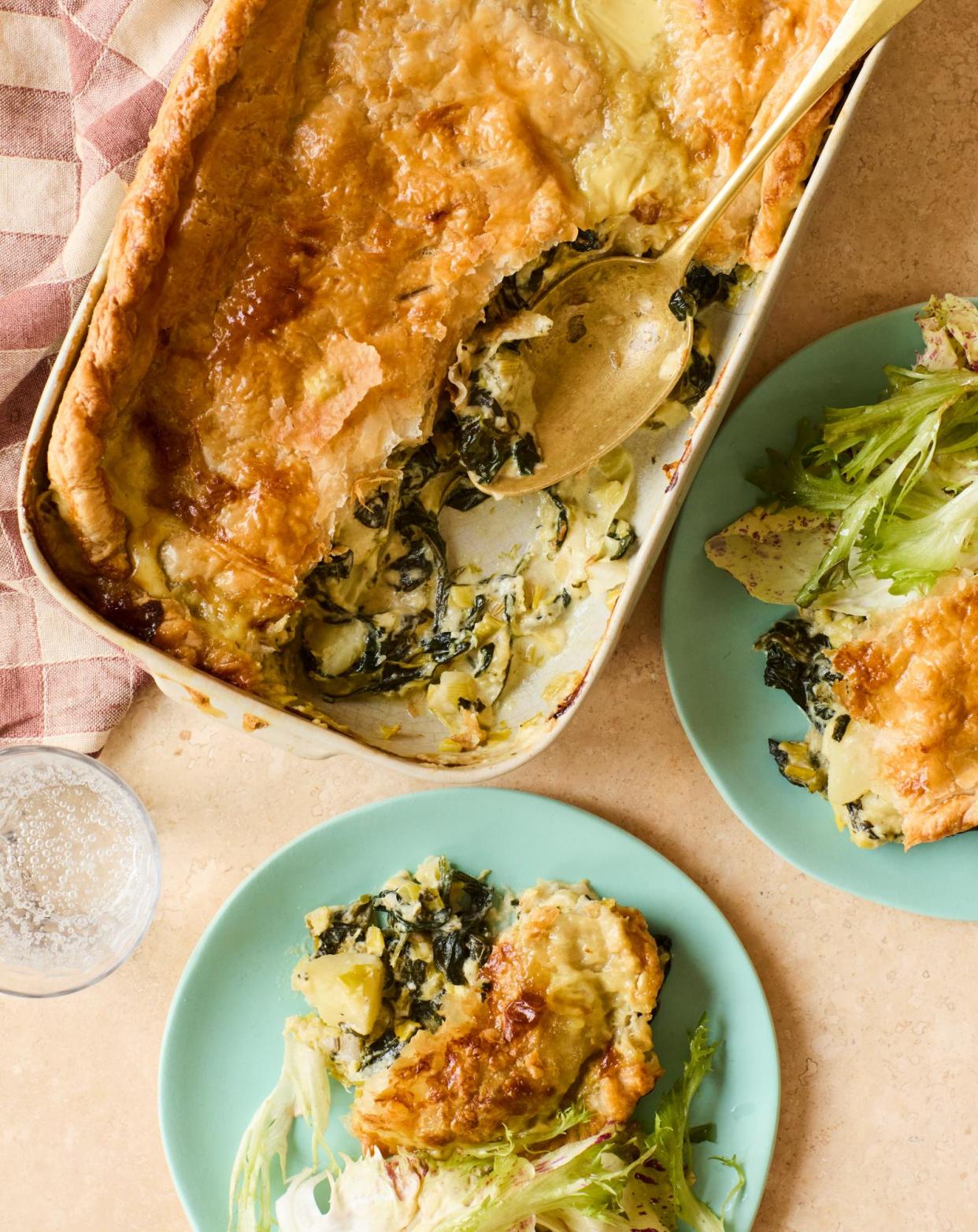 <span>Thomasina Miers’ leek, spinach and sheep’s cheese pie with rosemary garlic cream.</span><span>Photograph: Ola O Smit/The Guardian. Food styling: Sam Dixon. Prop styling: Anna Wilkins. Food styling assistant: Kristine Jakobssen.</span>