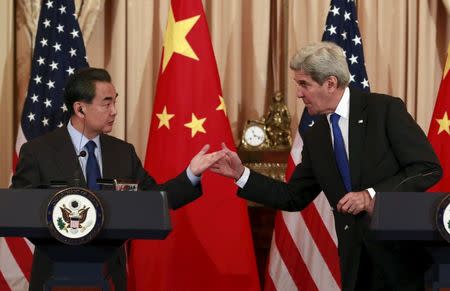 U.S. Secretary of State John Kerry (R) and Chinese Foreign Minister Wang Yi hold a joint news conference after their meeting at the State Department in Washington, February 23, 2016. REUTERS/Yuri Gripas TPX IMAGES OF THE DAY