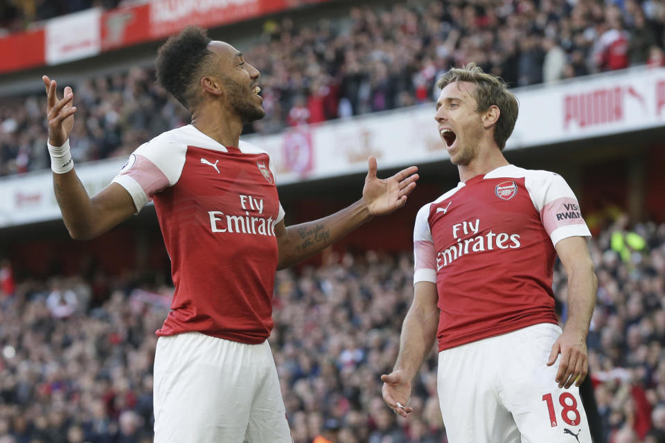 Arsenal's Pierre-Emerick Aubameyang, left celebrates with Arsenal's Nacho Monreal after scoring his side's 2nd goal during an English Premier League soccer match between Arsenal and Everton at the Emirates Stadium in London, Sunday Sept. 23, 2018. (AP Photo/Tim Ireland)