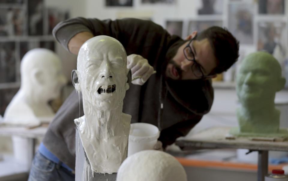 Paris' Grevin Wax Museum technician Matthieu Verrier works on the head of Rolling Stones lead singer Mick Jagger at their workshop in Paris