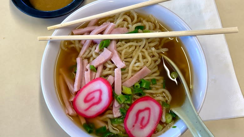 Hawaiian saimin in a glass bowl  with chopsticks