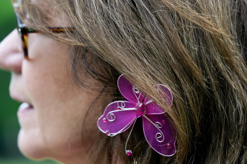 Tammy Ulreich, 64, wears a butterfly pin in her hair during Butterflies for Katelyn Markham.