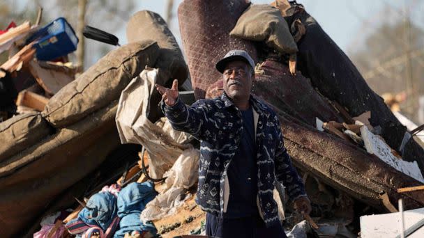 PHOTO: A resident looks through the piles of debris, insulation, and home furnishings to see if anything is salvageable at a mobile home park in Rolling Fork, Miss., Saturday, Mar. 25, 2023. (Rogelio V. Solis/AP)