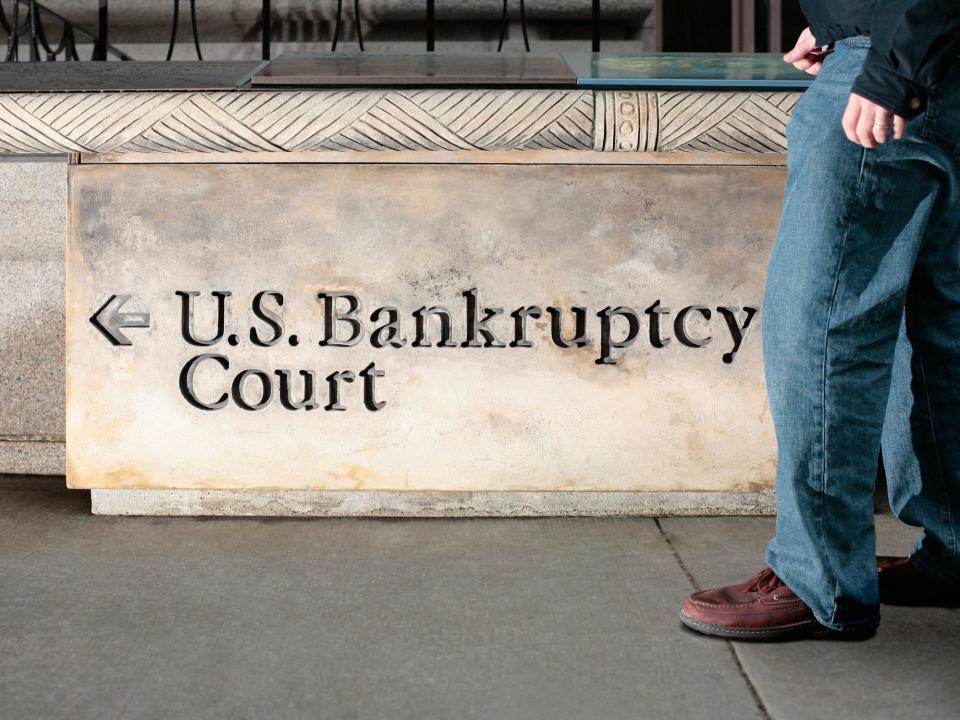 A man walks in front of a United States Bankruptcy Court sign in New York City.