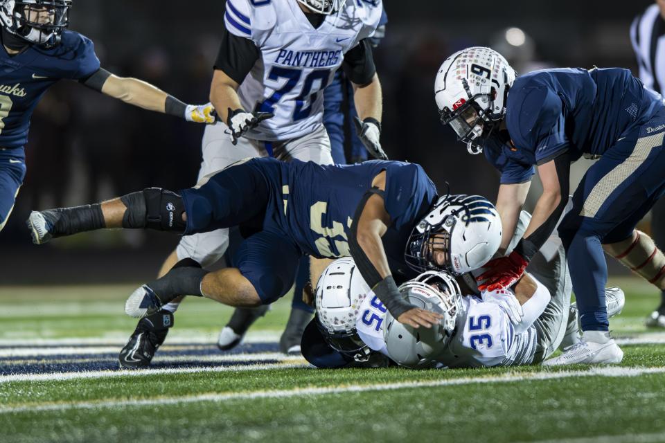 Decatur High School senior Halbert Aguirre (35) hits Bloomington South High School senior Gavin Adams (35) during the first half of an IHSAA Class 5A Semi-State football game, Friday, Nov. 17, 2023, at Decatur Central High School.