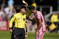 ADD ID OF REFEREE - Referee Lorenzo Hernandez issues a yellow card to Inter Miami center back Tomas Aviles during the first half of an MLS soccer match against DC United at Audi Field, Saturday, March 16, 2024, in Washington. (AP Photo/Nathan Howard)