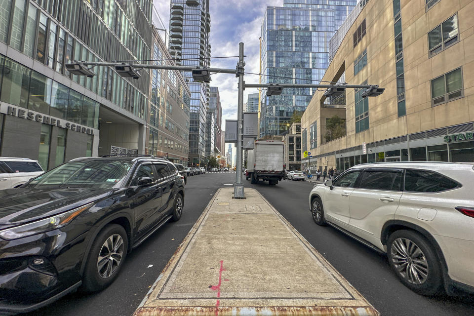 FILE - Recently installed toll traffic cameras hang above West End Ave. near 61st Street in the Manhattan borough of New York, Friday, Nov. 16, 2023. The start date for the $15 toll most drivers will be charged to enter Manhattan's central business district will be June 30, transit officials said Friday, April 26, 2024. (AP Photo/Ted Shaffrey, File)