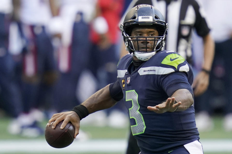 Seattle Seahawks quarterback Russell Wilson passes against the New England Patriots during the first half of an NFL football game, Sunday, Sept. 20, 2020, in Seattle. (AP Photo/Elaine Thompson)