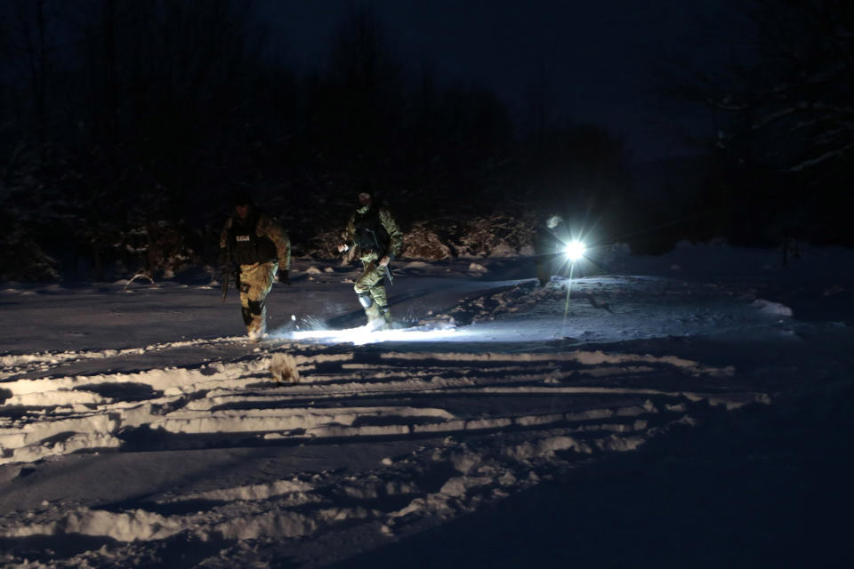 Bosnian police return from chasing a suspected serial killer in the village of Medvjedice 30 kms south of Sarajevo, Bosnia, Tuesday, Feb. 12, 2019. Bosnia police on Tuesday shot and killed the country's most-wanted fugitive, who had been sought in the slayings of a police officer and another person, after a huge manhunt. Edin Gacic died after a shootout with police near the capital Sarajevo, police said. (AP Photo/Amel Emric)