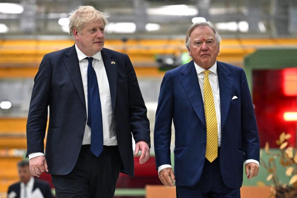 Former PM Boris Johnson and JCB chairman Lord Anthony Bamford (POOL/AFP via Getty Images)