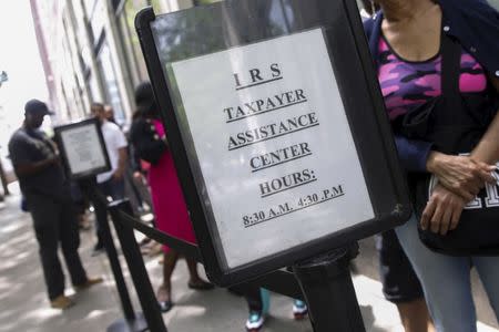 People wait outside the Internal Revenue Service office in the Brooklyn borough of New York May 27, 2015. REUTERS/Shannon Stapleton