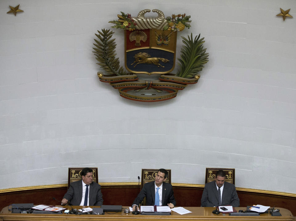 FILE - In this Jan. 15, 2019 file photo, leaders of the opposition-controlled National Assembly, President Juan Guaido, center, First Vice President Edgar Zambrano, left, and second Vice President Stalin Gonzalez hold a session with lawmakers at the National Assembly to debate actions against Venezuelan President Nicolas Maduro, in Caracas, Venezuela. Guaido stunned Venezuelans on Wednesday, Jan. 23, 2019 by declaring himself interim president before cheering supporters in Venezuela’s capital, buoyed by massive anti-government protests. (AP Photo/Fernando Llano, File)