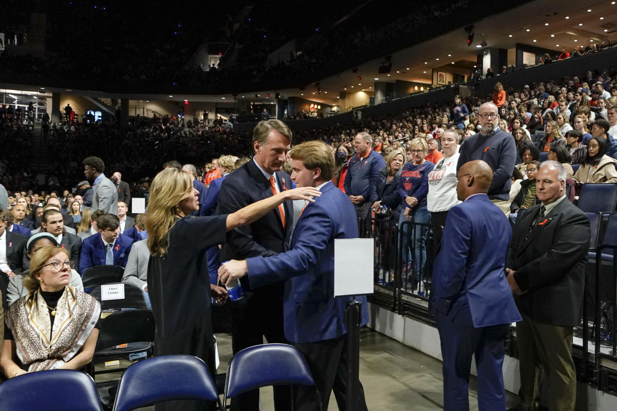 Virginia Gov. Glenn Youngkin and his wife Suzanne Youngkin greet a University of Virginia football player before a memorial service for three slain University of Virginia football players Lavel Davis Jr., D'Sean Perry and Devin Chandler at John Paul Jones Arena at the school in Charlottesville, Va., Saturday, Nov. 19, 2022. (AP Photo/Steve Helber, Pool)