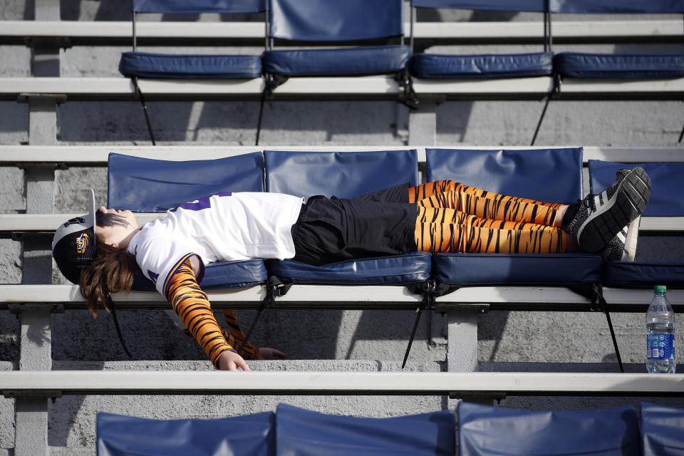 An LSU fan takes a nap during the second quarter of an NCAA college football game against Auburn, Saturday, Oct. 31, 2020, in Auburn, Ala. (AP Photo/Butch Dill)