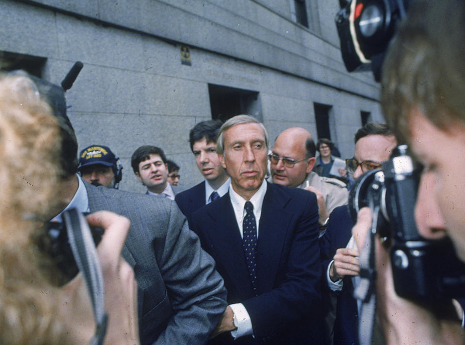 FILE - Ivan F. Boesky, center, leaves federal court in New York, April 24, 1987 after pleading guilty to one count of violating federal securities laws. Boesky, the flamboyant stock speculator whose cooperation with the government cracked open one of the largest insider trading scandals on Wall Street, has died at the age of 87. (AP Photo/G. Paul Burnett, File)