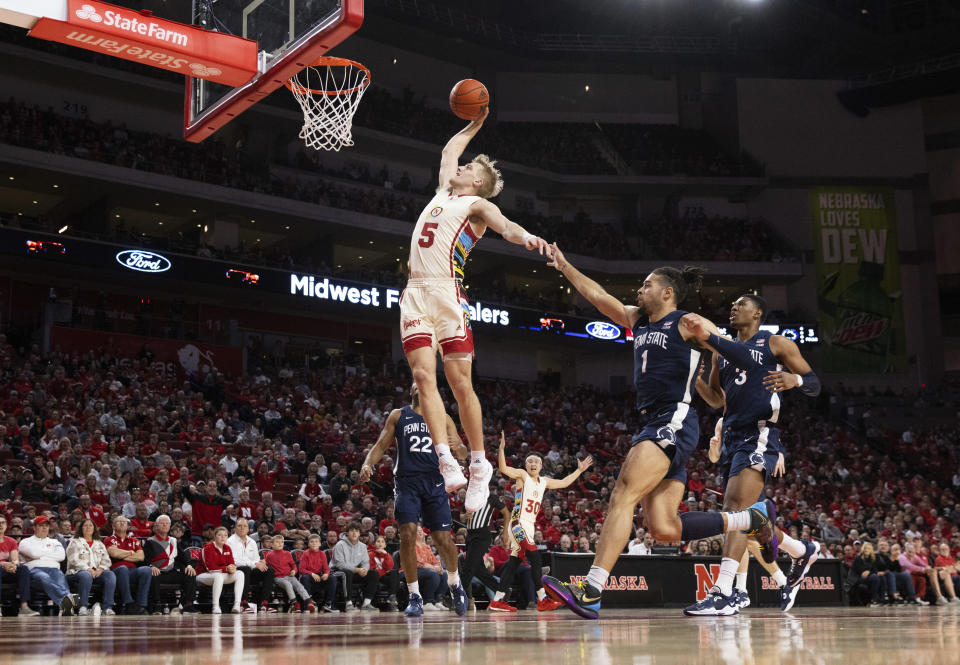 Nebraska's Sam Griesel (5) dunks against Penn State's Jalen Pickett (22), Seth Lundy (1) and Kebba Njie (3) during the first half of an NCAA college basketball game Sunday, Feb. 5, 2023, in Lincoln, Neb. (AP Photo/Rebecca S. Gratz)