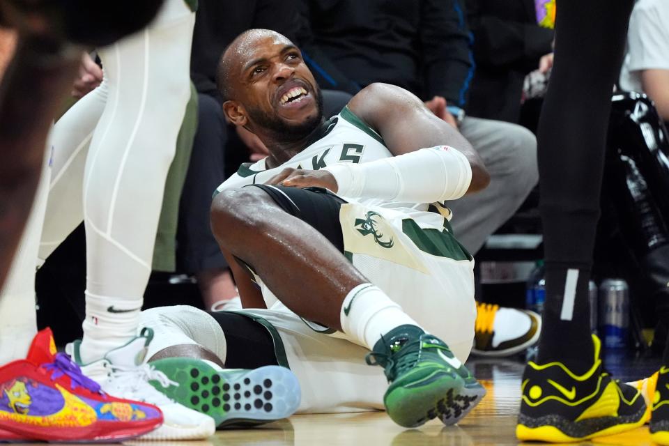 Bucks forward Khris Middleton grimaces on the court after being injured during the first half against the Suns on Tuesday night.