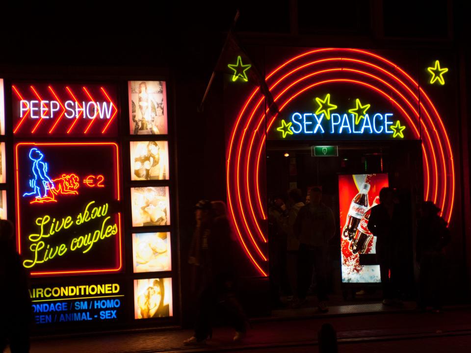 NETHERLANDS - 2006/12/30: A street scene at night with colorful neon signs of a sex shop in the red light district of Amsterdam in the Netherlands (Holland). (Photo by Wolfgang Kaehler/LightRocket via Getty Images)