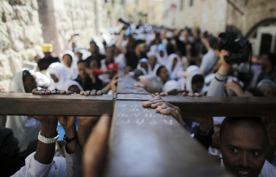 Christian worshippers carry a cross during a procession along the Via Dolorosa on Good Friday in Jerusalem's Old City