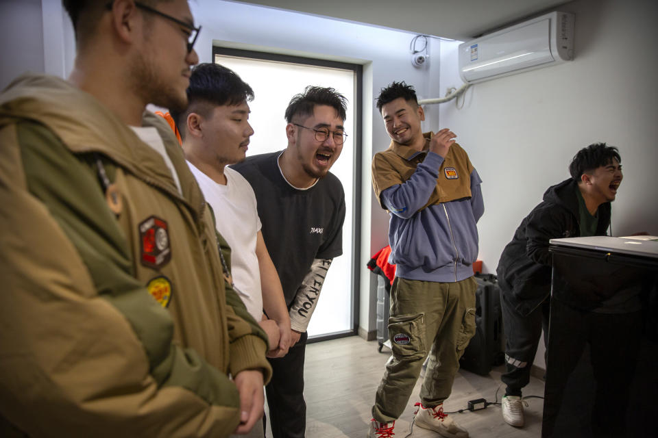 Members of the Chinese music group Produce Pandas, from left, Husky, Otter, DING, Mr. 17, and Cass, react while practicing their vocals during rehearsals in Beijing, Thursday, April 15, 2021. The Produce Pandas proudly call themselves "the first plus-sized boy band in China." That's a radical departure from the industry standard set by Korean super groups such as BTS, whose lanky young members are sometimes referred to in China as "little fresh meat." (AP Photo/Mark Schiefelbein)