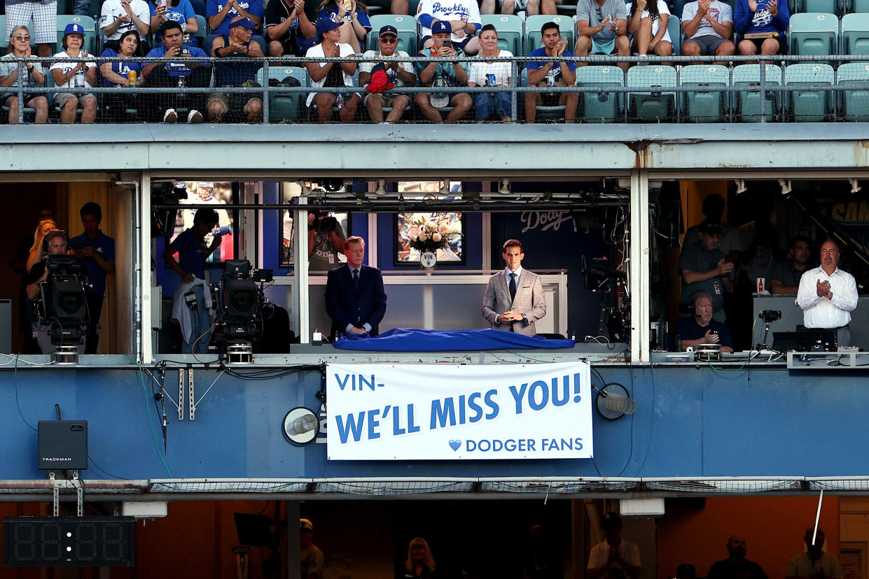 LOS ANGELES, CALIFORNIA - AUGUST 05: A banner honoring Hall of Fame broadcaster Vin Scully is unveiled during a pregame ceremony prior to the game between the San Diego Padres and the Los Angeles Dodgers at Dodger Stadium on August 05, 2022 in Los Angeles, California. Scully passed away at age 94 on August 02, 2022. (Photo by Harry How/Getty Images)