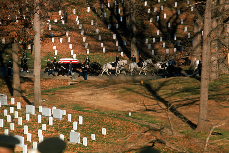Caption from LIFE. "With the sound of creaking wheels and clattering hoofs breaking the silence, the President's caisson entered Arlington Cemetery, passed the graves of American war heroes and headed toward the burial spot on a grassy hill which looks over the Potomac." (John Loengard—Time & Life Pictures/Getty Images) <br> <a href="http://life.time.com/history/john-f-kennedys-funeral-photos-from-arlington-cemetery-november-1963/#1" rel="nofollow noopener" target="_blank" data-ylk="slk:Click here to see the full collection at LIFE.com;elm:context_link;itc:0;sec:content-canvas" class="link ">Click here to see the full collection at LIFE.com</a>
