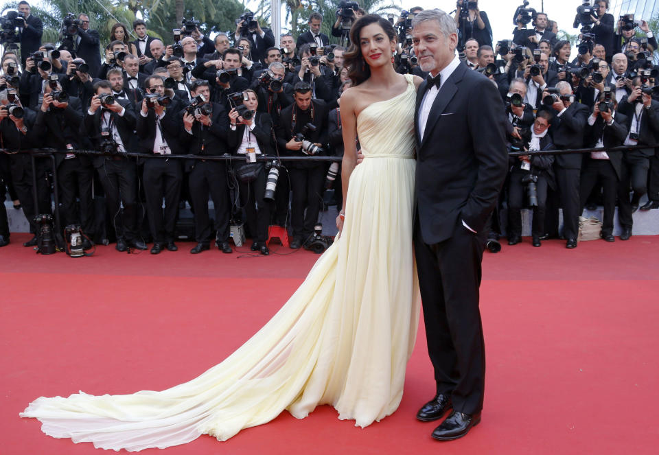 Cast member George Clooney and his wife Amal pose on the red carpet for the screening of the film "Money Monster" out of competition at the 69th Cannes Film Festival in Cannes, France, May 12, 2016. REUTERS/Regis Duvignau